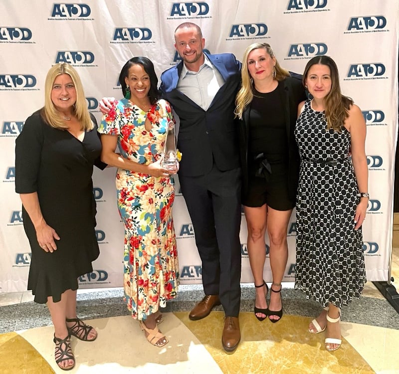 Maiysha Ware in group photo celebrating award with colleagues